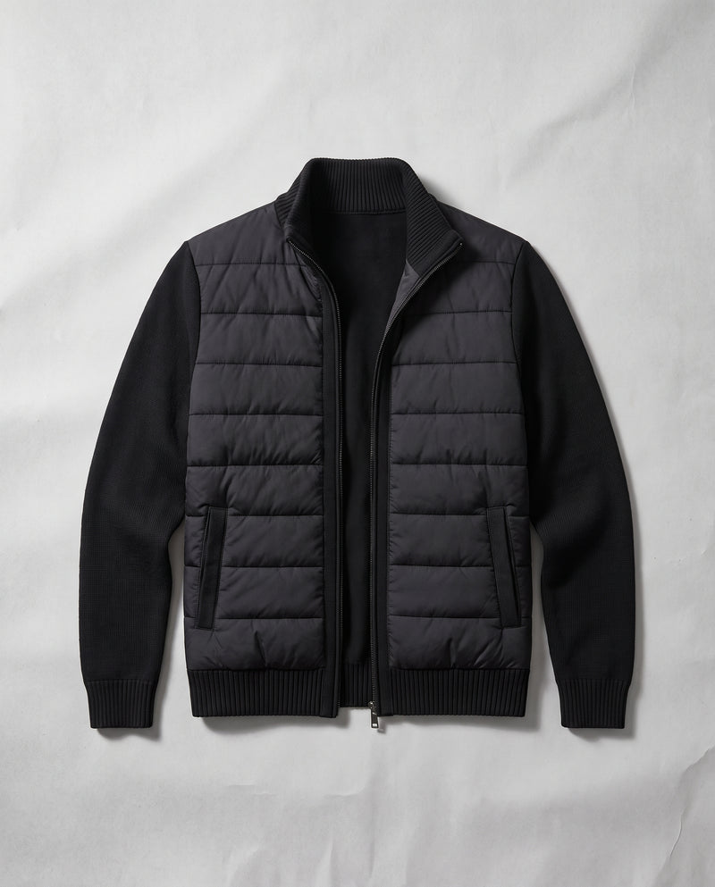 Black Bellardi hybrid puffer jacket laid flat, zip open, no model — quilted front panel and knitted sleeves in a solid, flat black (not heathered), two piped hip pockets.