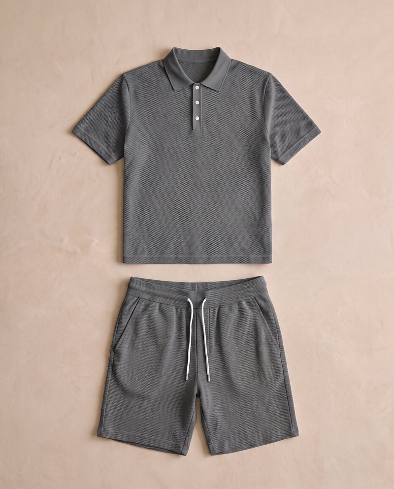 Ensemble polo et short en maille texturée gris anthracite, posé à plat