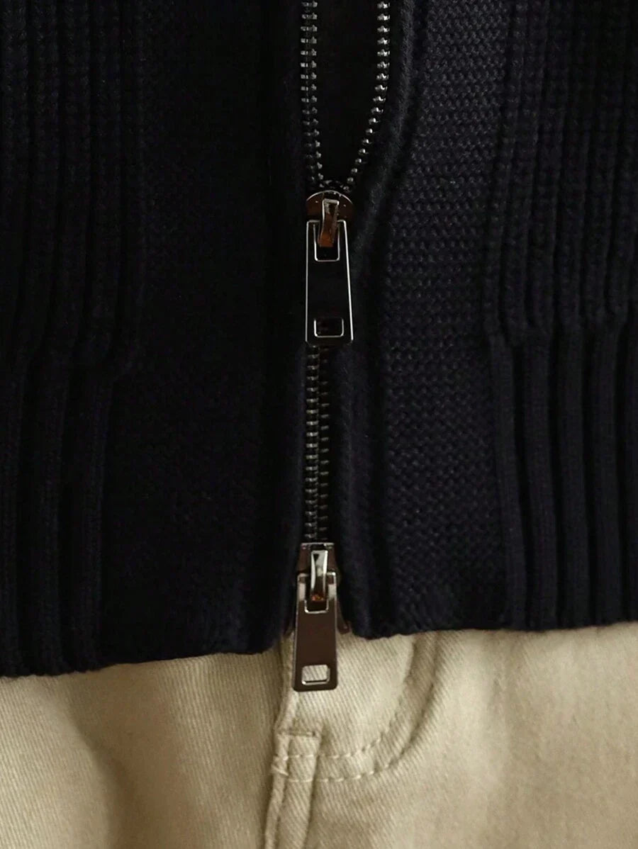 Close-up of the two-way zip at the hem of the black cardigan
