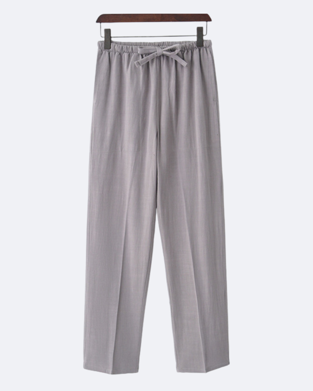 Light grey drawstring trousers on a wooden hanger, front view