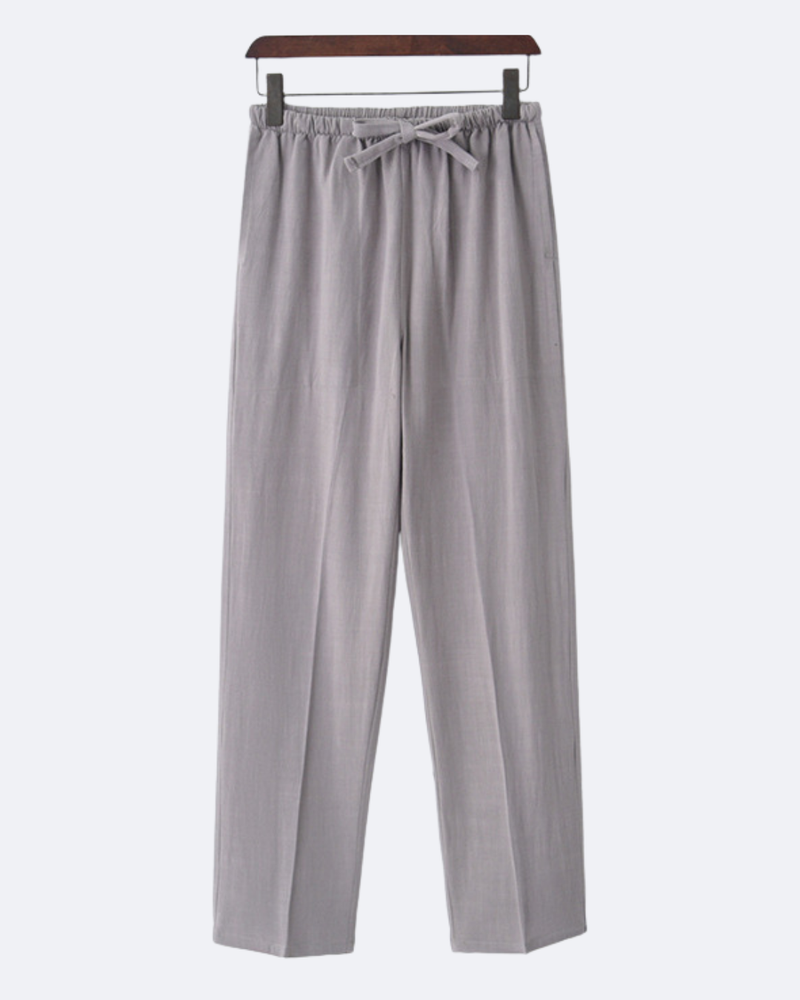 Pantalon gris clair à cordon de serrage sur un cintre en bois, vue de face
