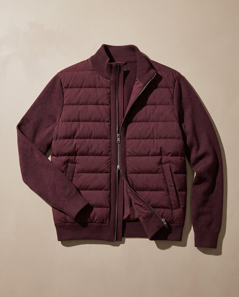Bellardi Hybrid Puffer Jacket in Burgundy, laid flat and unzipped, showing the quilted front panel and knit sleeves.