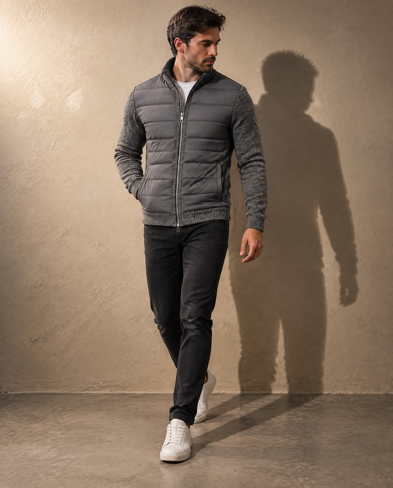 Bellardi Hybrid Puffer Jacket in Dark Grey, full length, worn while walking, showing the ribbed hem and welt pockets