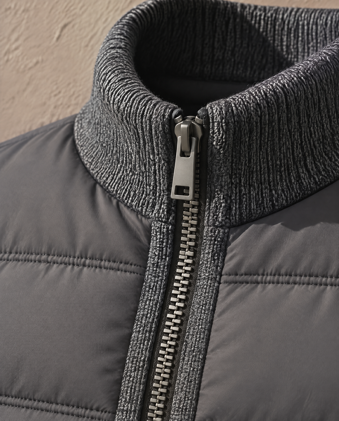 Close-up of the standing collar and single-pull centre-front zip on the Bellardi Hybrid Puffer Jacket in Dark Grey