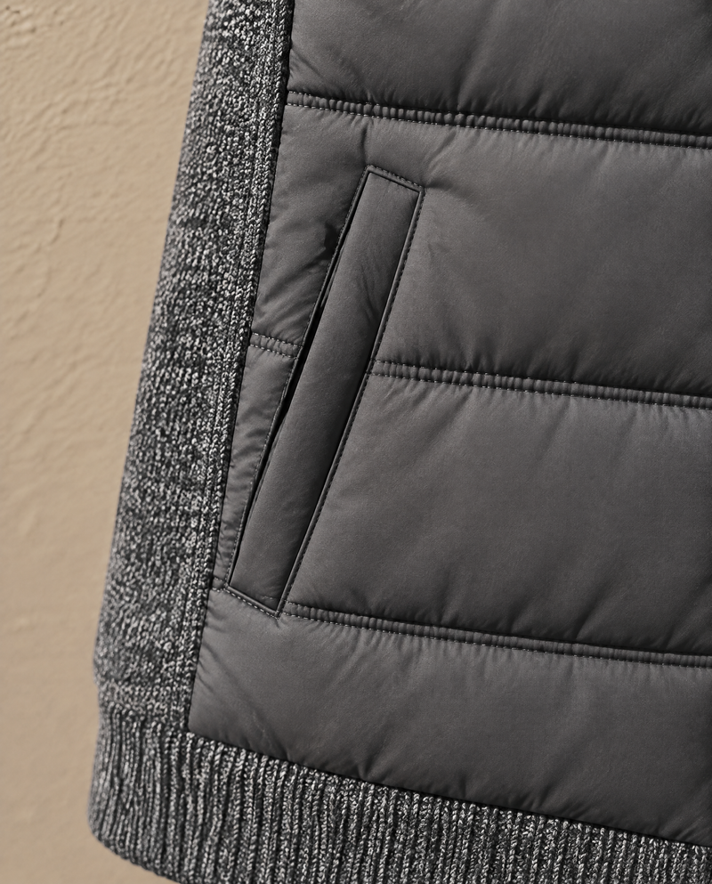 Close-up of the angled hip welt pocket on the Bellardi Hybrid Puffer Jacket in Dark Grey