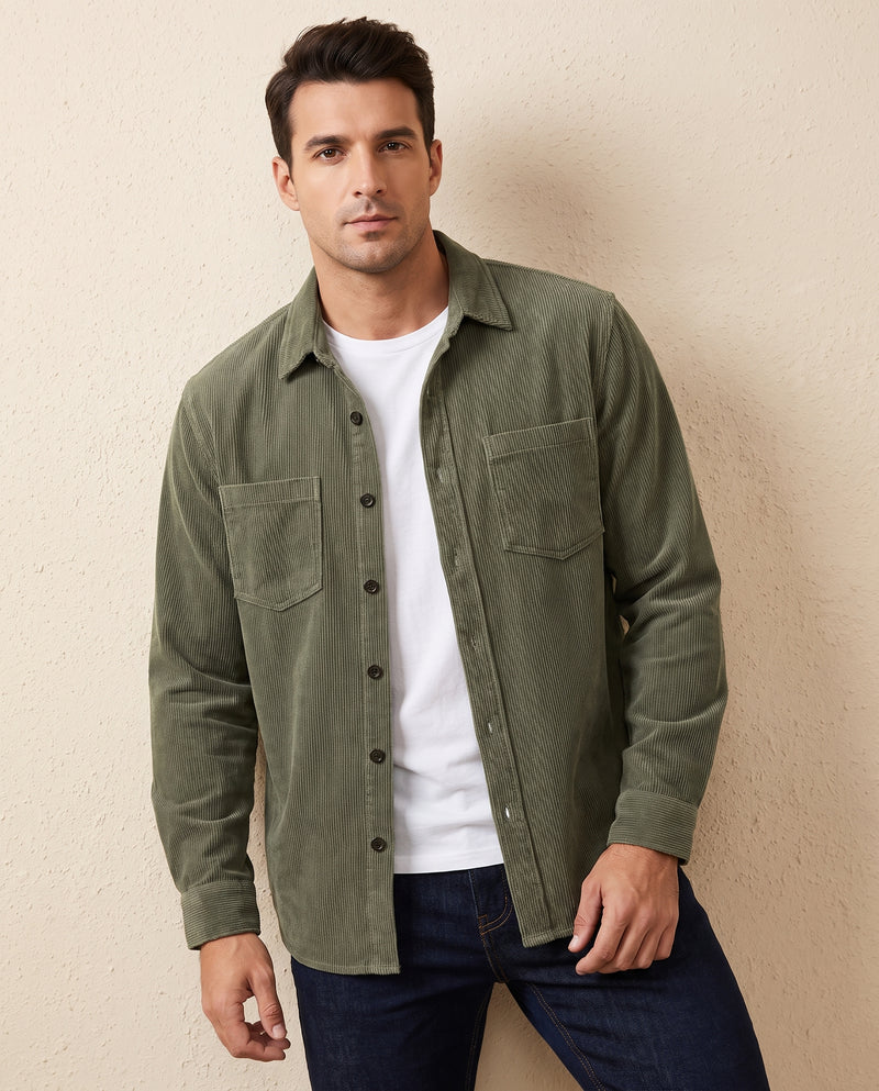 Man wearing an army green corduroy overshirt open over a white t-shirt, lit by one window from the left